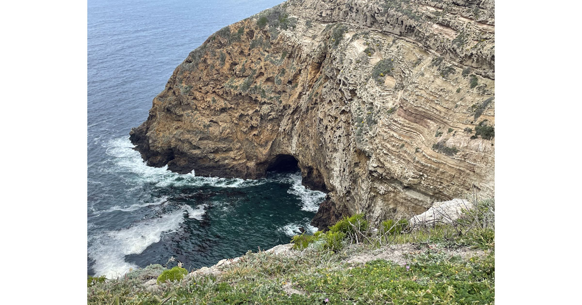 The island has picturesque caves and coves